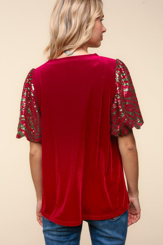 Back view of red velvet top with sequin sleeves