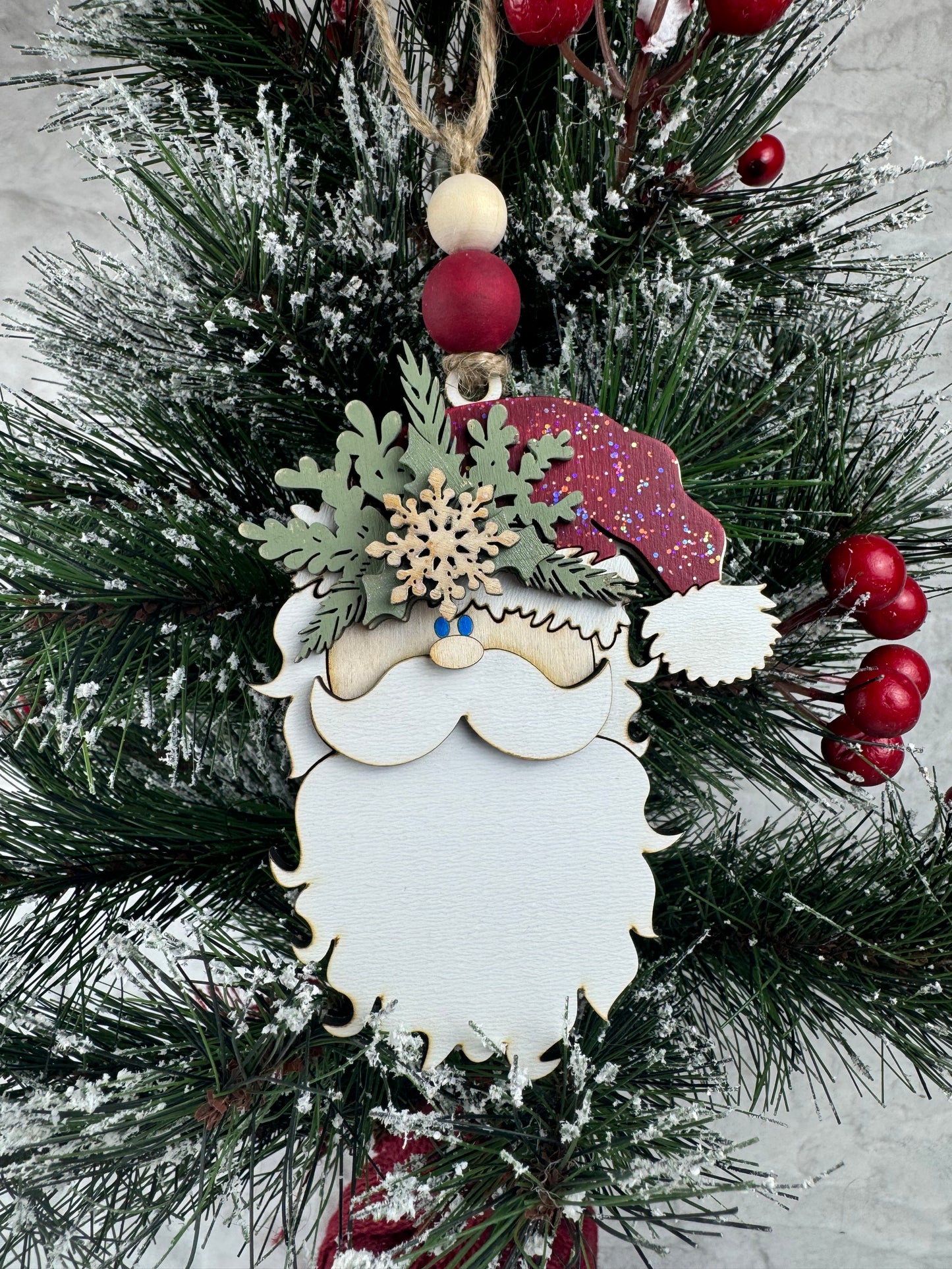 Santa ornament with festive hat on Christmas tree