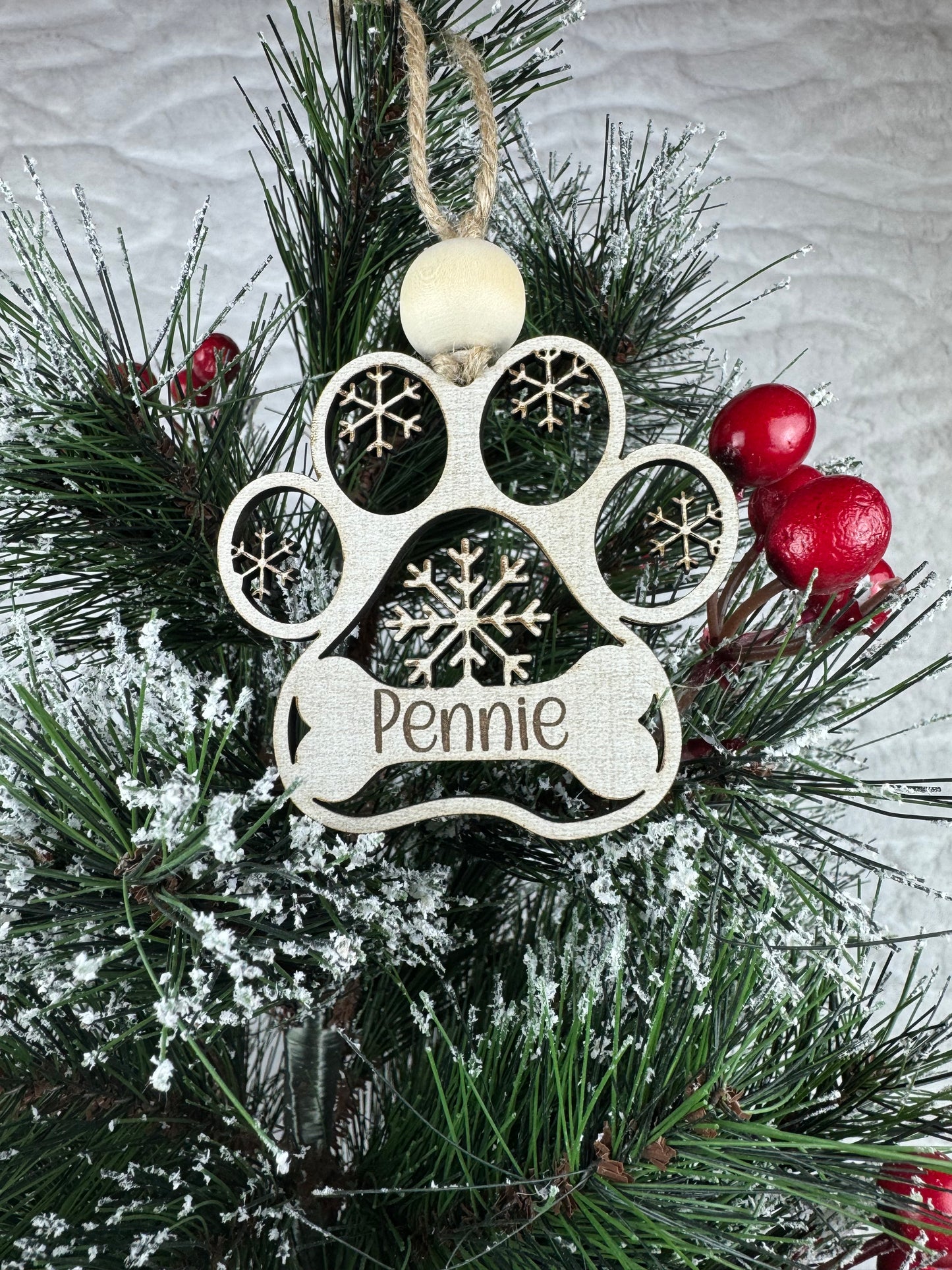 Holiday dog ornament with snowflakes on tree