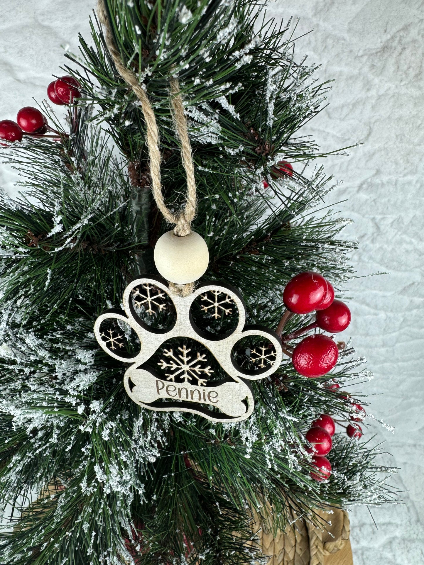 Personalized paw ornament on decorated tree