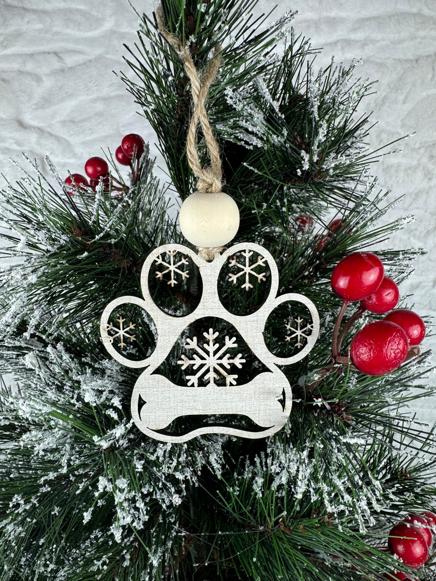 Blank dog paw ornament with snowflakes on tree