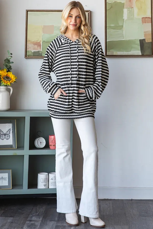 Striped puff sleeve hoodie with white pants indoors