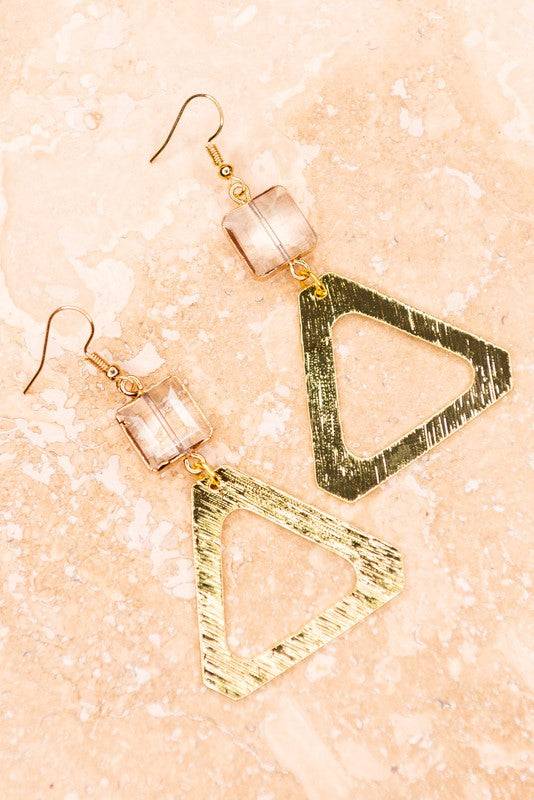 Shop Jessica Triangle Earrings with brushed gold triangle drops and translucent crystal cubes, a chic accessory for casual or dressy outfits.
