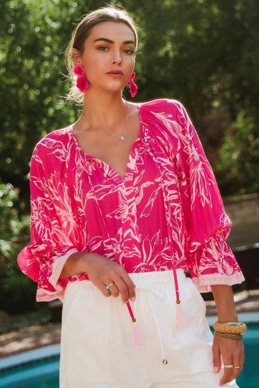 Plus-size Floral Printed Blouse - Stylish & Comfortable with bold floral print and airy sleeves, styled with white drawstring pants for a relaxed outfit.
