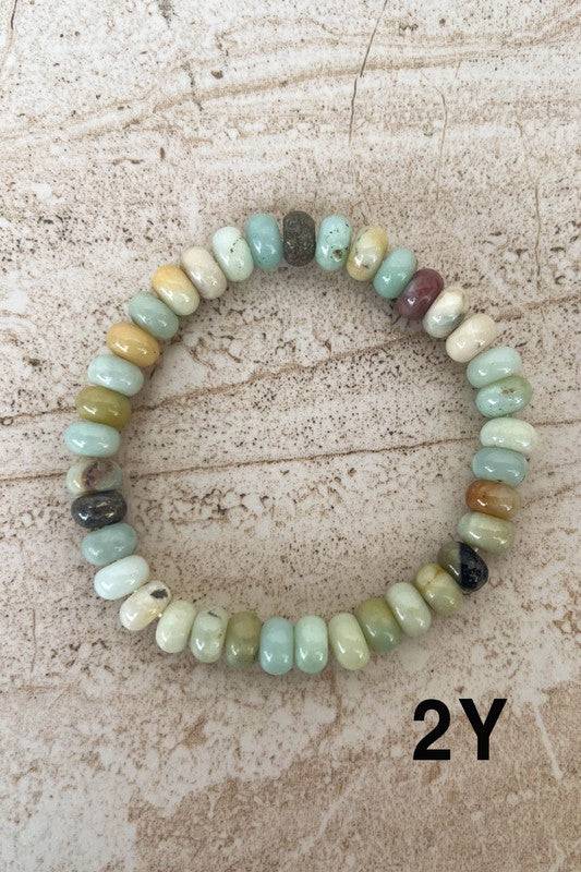 Pastel-toned Stone Bead Bracelets with flat disc-shaped beads in soft greens and yellows, perfect for a subtle, earthy look.