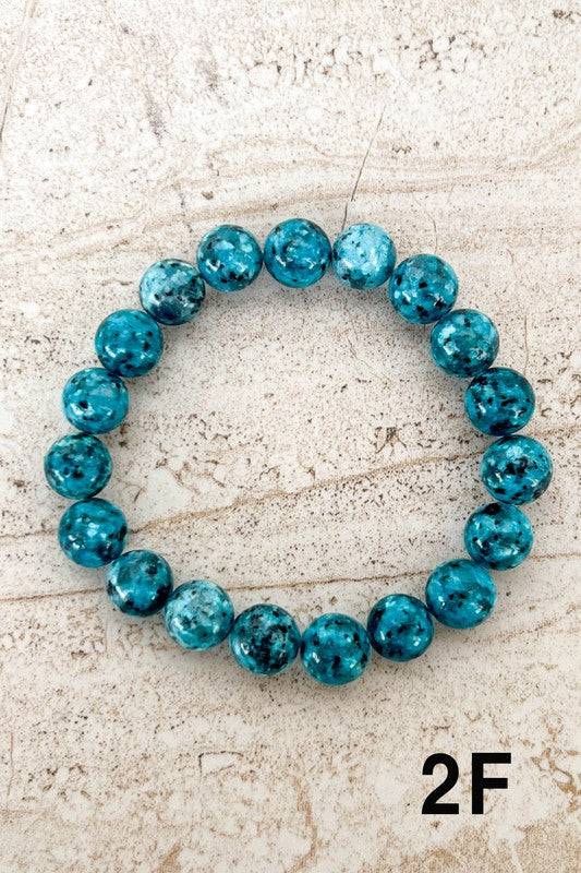 Bright blue Stone Bead Bracelets with black speckles, designed to stand out as a colorful and stylish accessory.