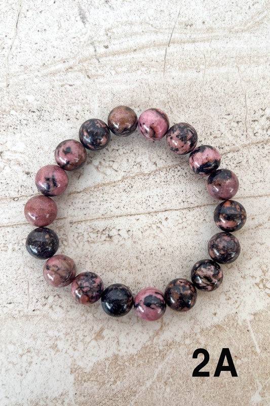 Pink and black marbled Stone Bead Bracelets with a glossy finish, adding a touch of elegance and contrast to your outfit.