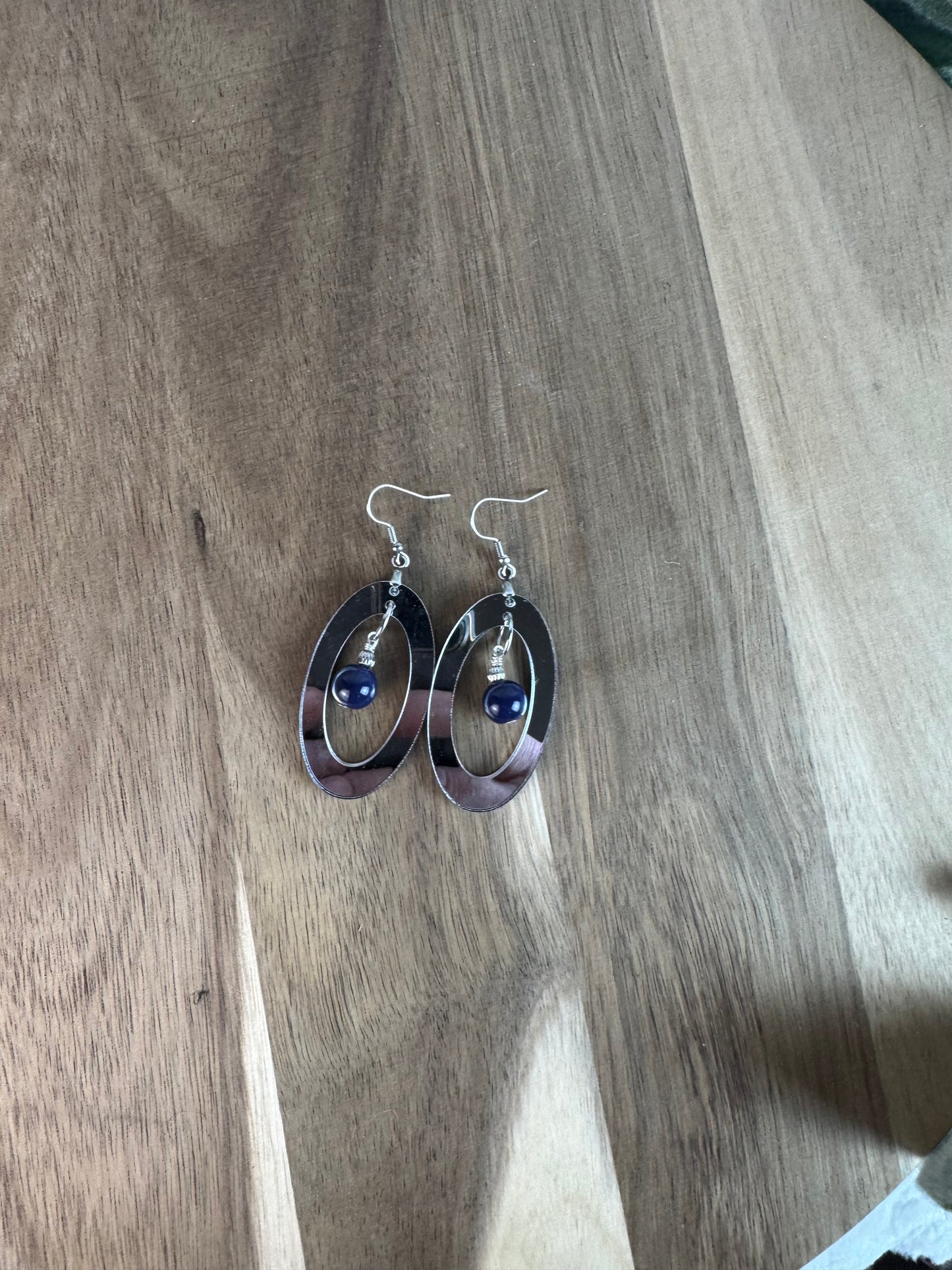 Silver Mirror Acrylic Oval Earrings with Blue Dangle Bead