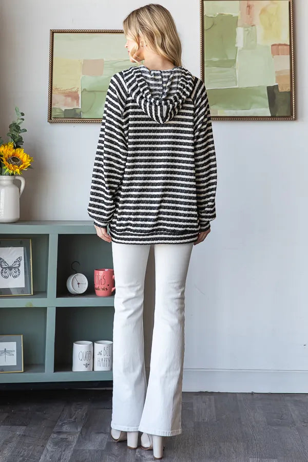 Back view of striped puff sleeve hoodie indoors