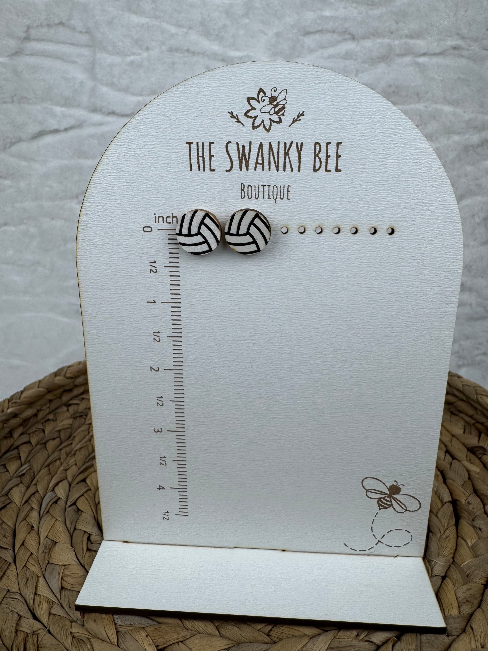 Volleyball studs earrings on measurement card