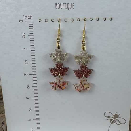 Leaf earrings showcased on boutique stand