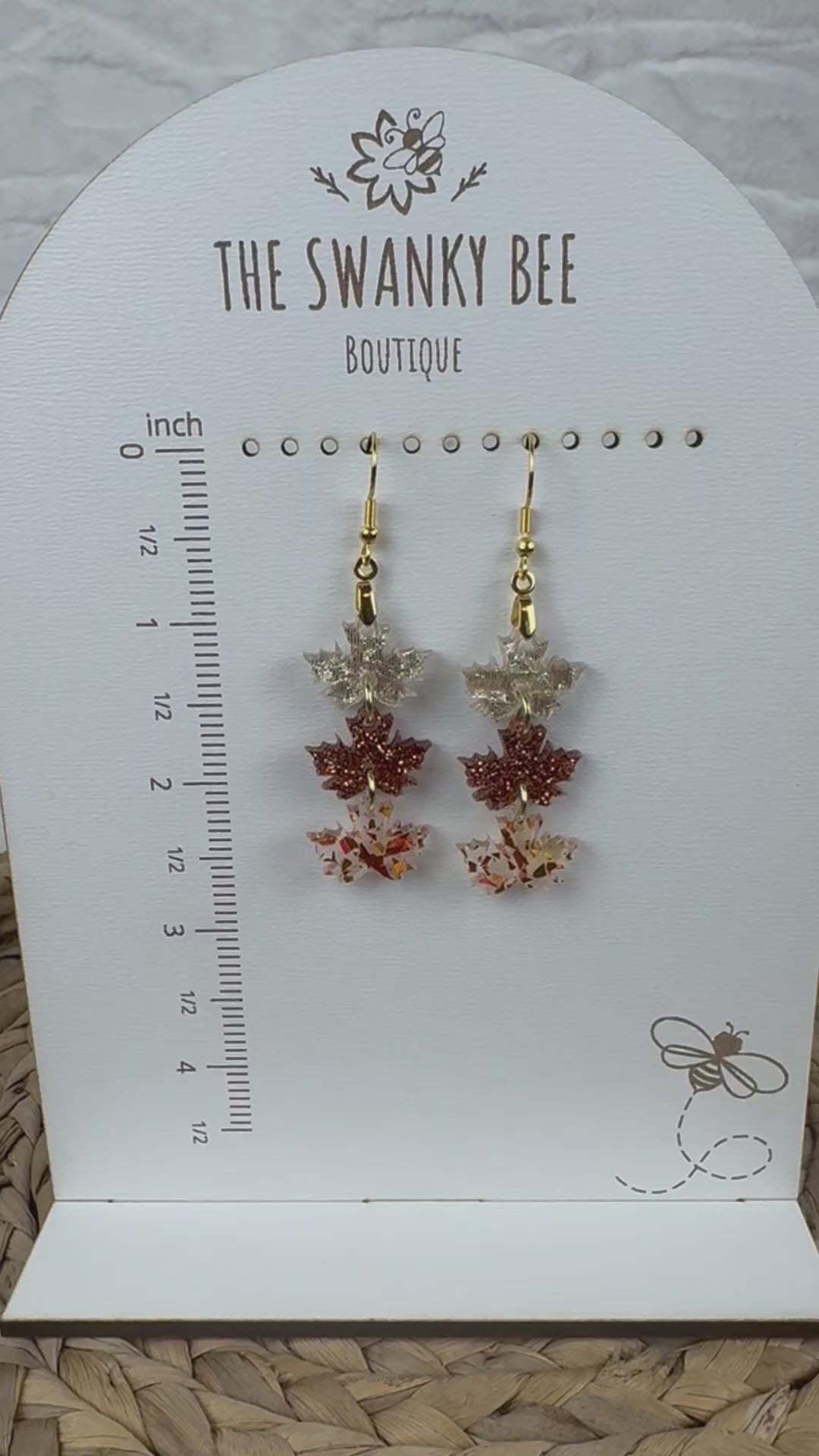 Leaf earrings showcased on boutique stand